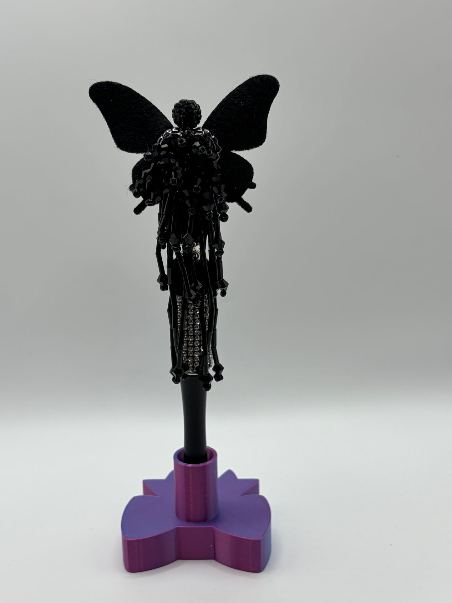 Black rhinestone butterfly with dangles.